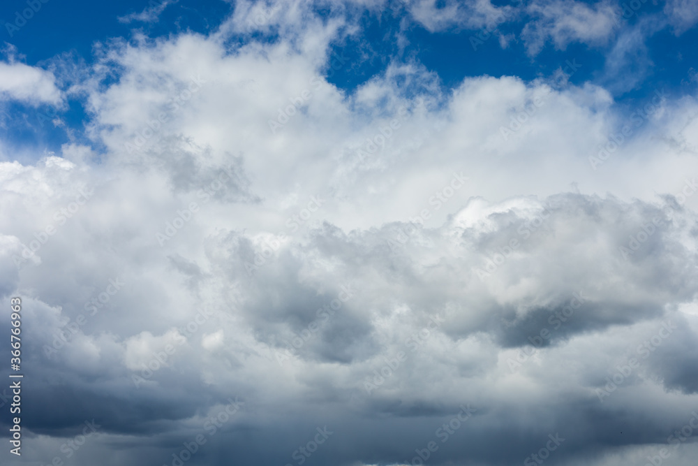 Beautiful blue sky background at daylight with white cumulus clouds.