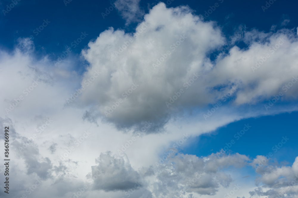 Beautiful blue sky background at daylight with white cumulus clouds.