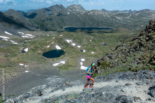 Trail runner woman running with view of river and trail path