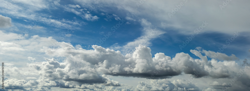 Beautiful blue sky background at daylight with white cumulus clouds. Backgroud panoramic banner.