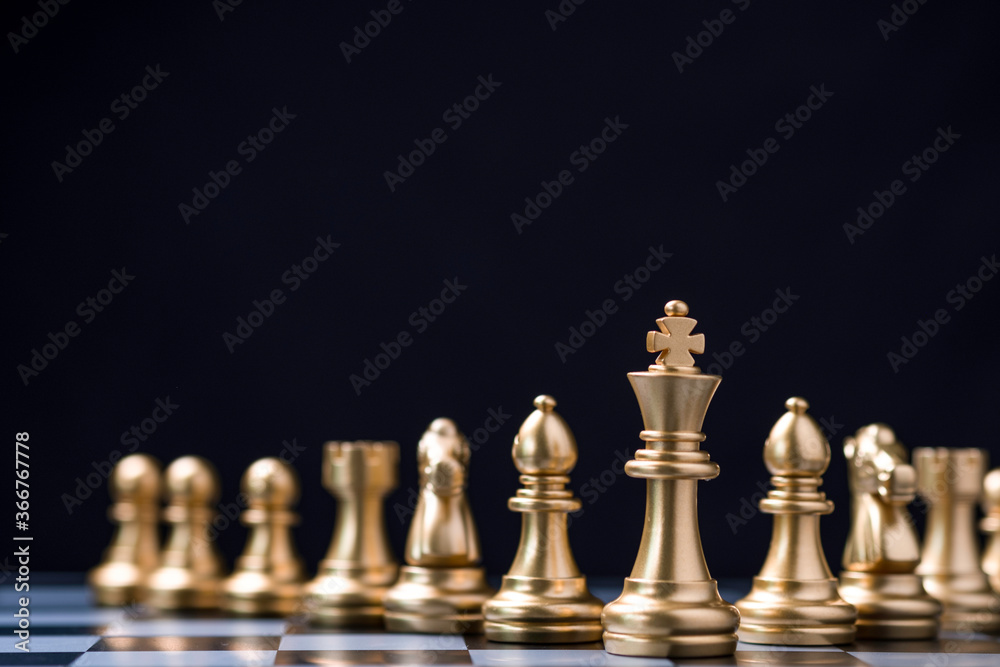 Golden king chess stand in front of others chess pieces. Leadership business teamwork and marketing strategy planing concept. Golden king chess stand in front of others chess pieces. Leadership business teamwork and marketing strategy planing concept.