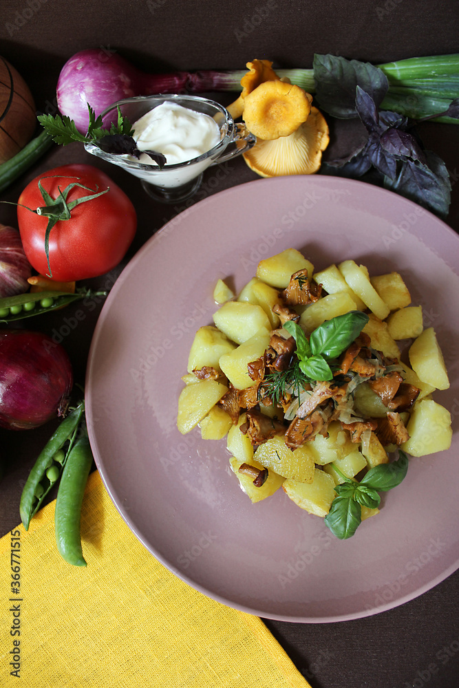 Fried potatoes with chanterelles and vegetables.Texture or background
