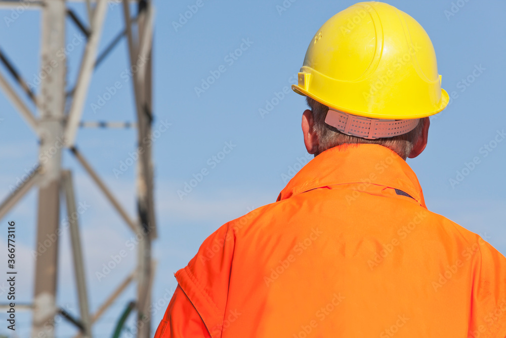 Engineer, foreman or worker with hard hat and protective clothing in front of industrial background Engineer, foreman or worker with hard hat and protective clothing in front of industrial background