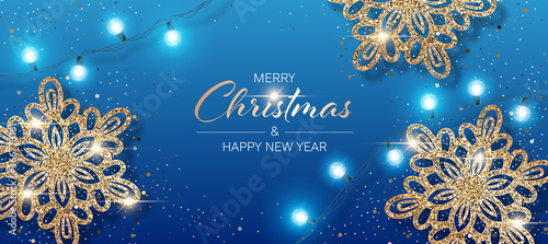 Christmas background with shiny snowflakes made of golden confetti and lights garlands. Design element for greeting card, party invitation or banner