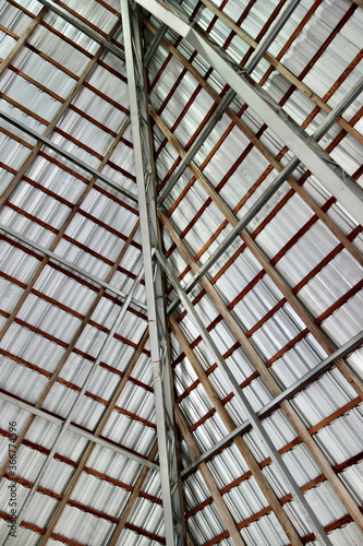Lower part of the structure of a metal roof with wooden beams photo