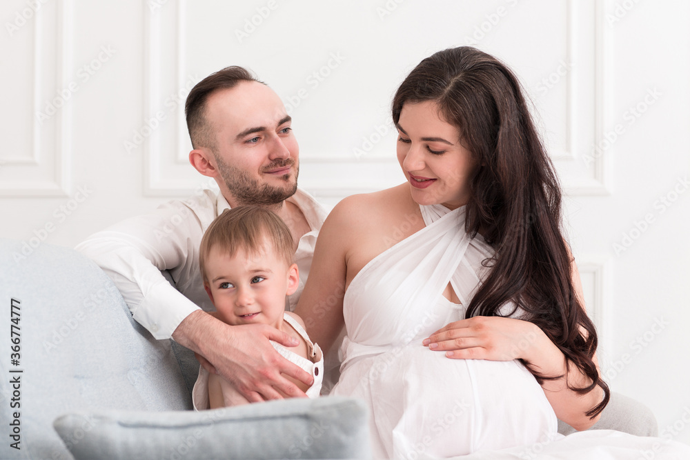 happy family in the living room married couple with small child and pregnant woman happy family in the living room married couple with small child and pregnant woman