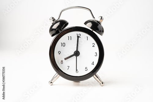 Black alarm clock isolated on white background.