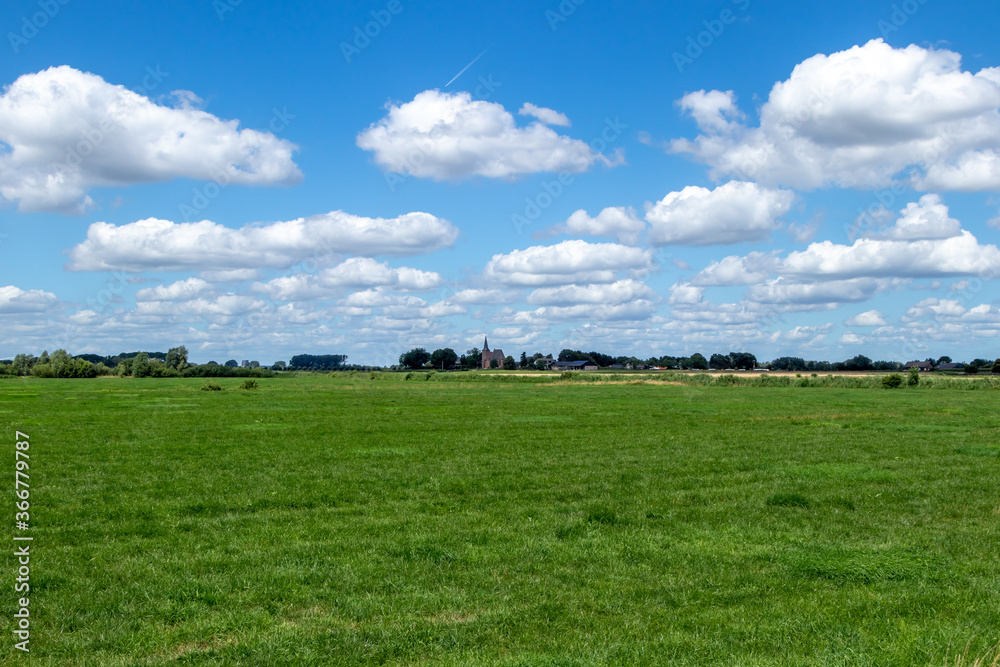 green field with blue sky