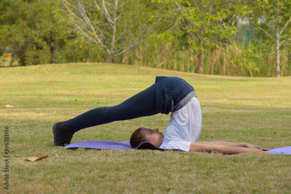 Fototapeta premium Young beautiful woman exercising at the park outdoors