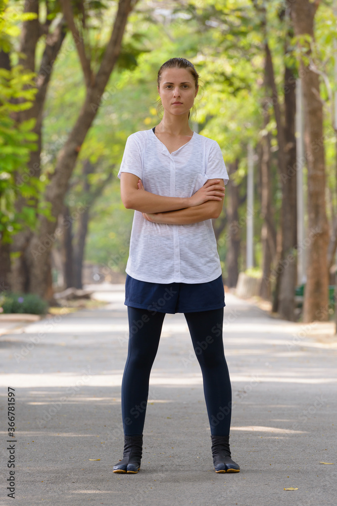 Young beautiful woman exercising at the park outdoors Young beautiful woman exercising at the park outdoors