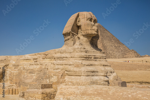 What remains of the Great Sphinx of Giza. The wonder that is the Great Pyramid can be seen hiding behind it 