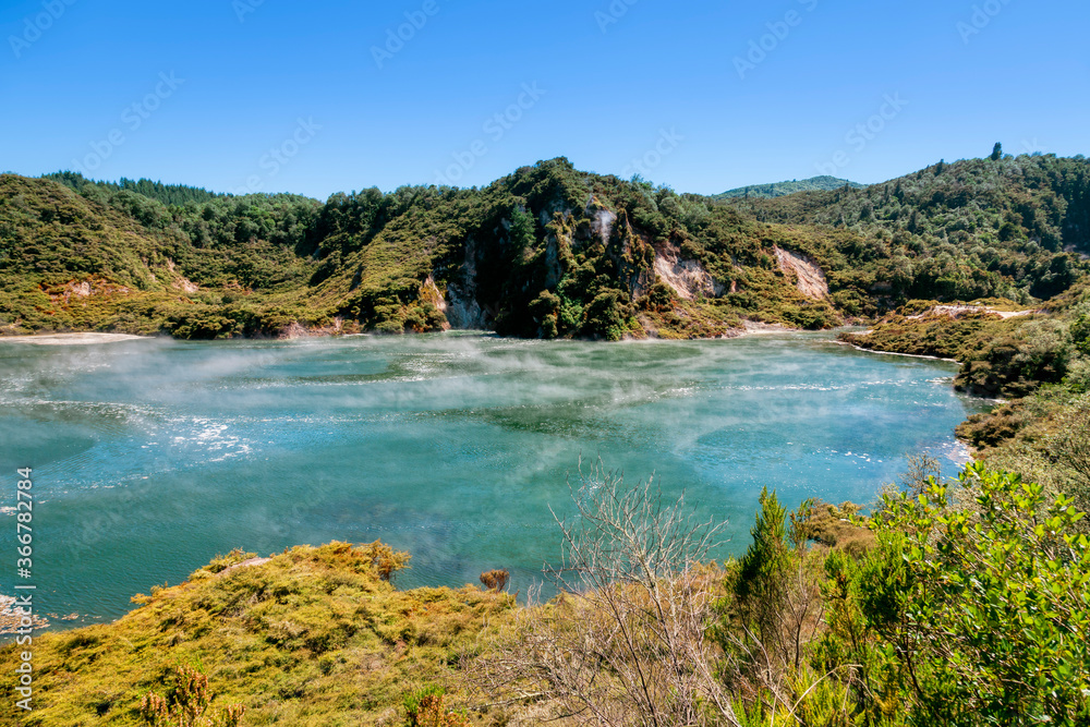 Green crater lake with rising steam in Waimangu Volcanic Valley