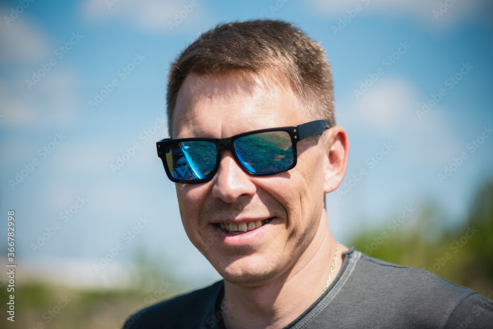 Smiling man in sunglasses close up. Smiling man in sunglasses close up.