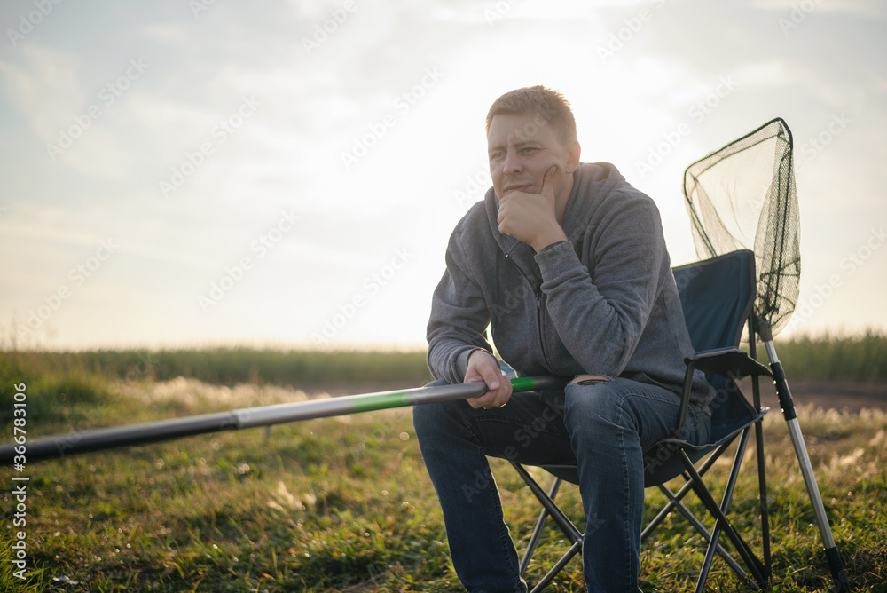 A fisherman is fishing on the lake. A fisherman is fishing on the lake.