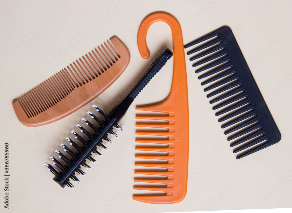 Combs and hair brush on pastel background. Hair care concept. Top view Combs and hair brush on pastel background. Hair care concept. Top view