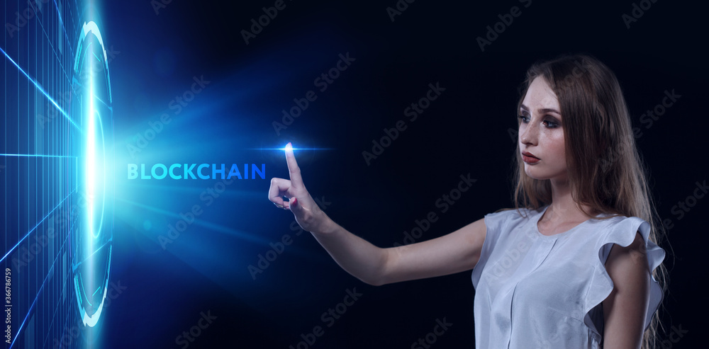 Business, Technology, Internet and network concept. Young businessman working on a virtual screen of the future and sees the inscription: Blockchain Business, Technology, Internet and network concept. Young businessman working on a virtual screen of the future and sees the inscription: Blockchain