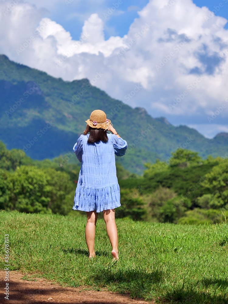 girl on vacation in natural green glass field with mountain view girl on vacation in natural green glass field with mountain view