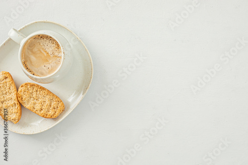 Styled minimal desktop mockup with coffee cup and crackers. Breakfast, Freelancer, social media blogger concept. Flat lay, top view