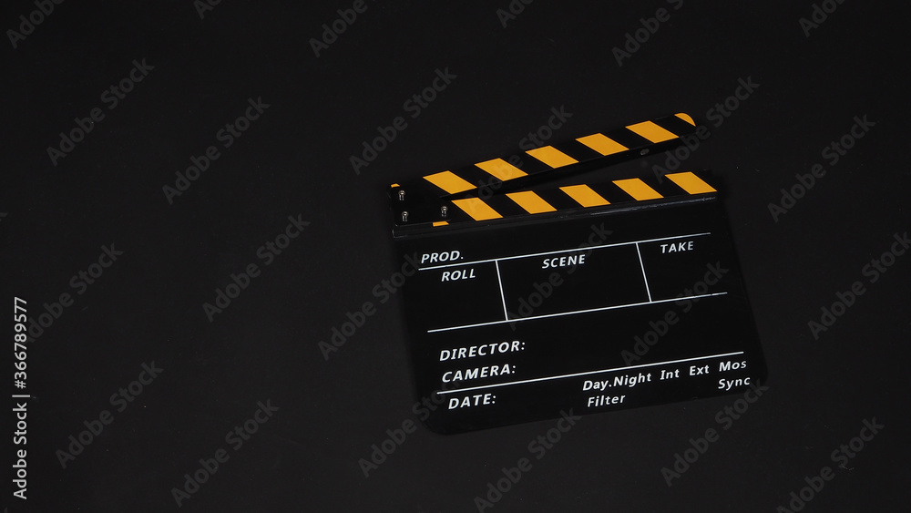 Clapperboard or movie slate on black background.it use in video production and film industry .