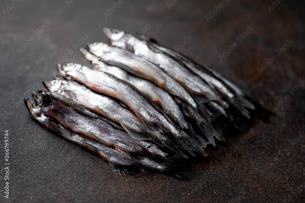 Fresh raw fish on a stone background. Selective focus Fresh raw fish on a stone background. Selective focus