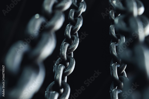 Strong brazed industrial chains on a black background.