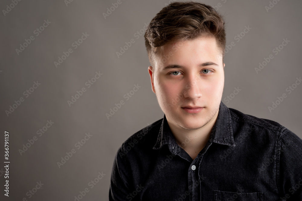 Fototapeta premium Head shot portrait of serious stylish attractive man dressed with a casual black shirt
