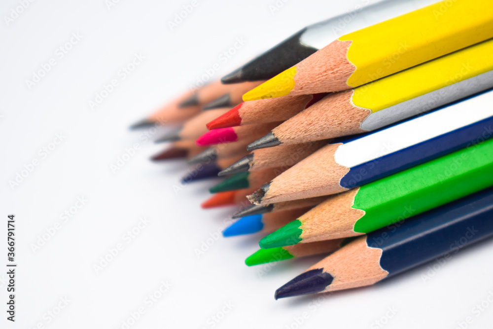 Pyramid shape made with some different colored wood pencil crayons on white background Pyramid shape made with some different colored wood pencil crayons on white background