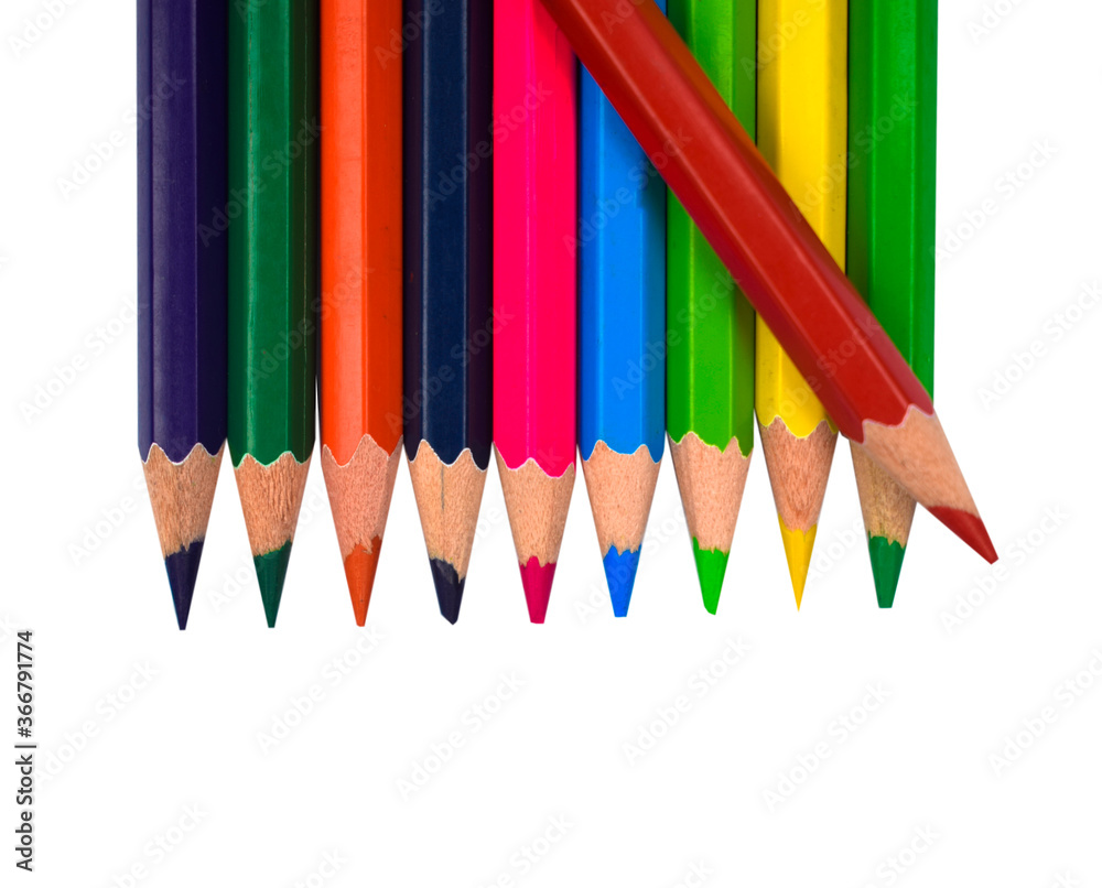 Red color wood pencil crayon placed on top of a row of different color wood pencil Red color wood pencil crayon placed on top of a row of different color wood pencil