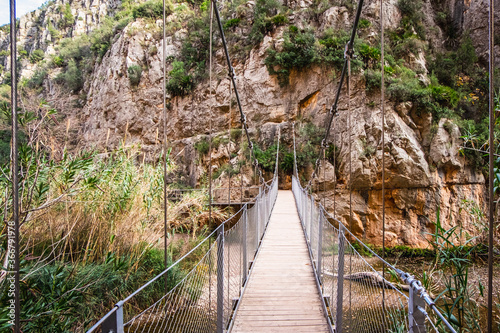 Footbridge  rope suspension bridge over the river Turia  Puentes Colgantes  Charco Azul  Chulilla  Spain