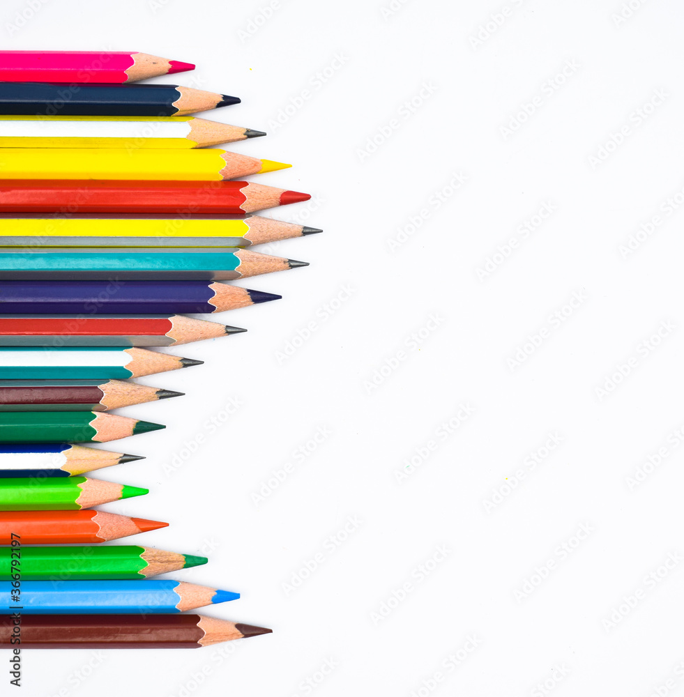 Wave gesture of a line of different color wood pencil crayon on a white background Wave gesture of a line of different color wood pencil crayon on a white background