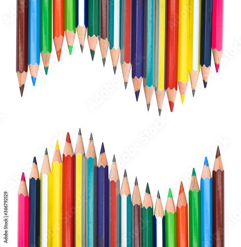 Two row of different color wood pencil crayon facing each on a white background