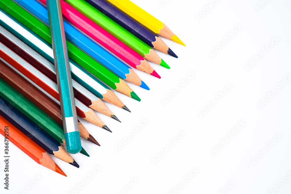 Light blue color wood pencil crayon placed on top of a row of different color wood pencil Light blue color wood pencil crayon placed on top of a row of different color wood pencil