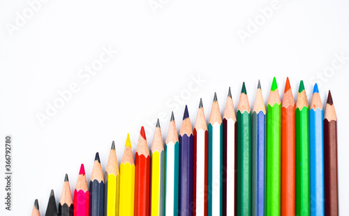 Line according to size of some different color wood pencil crayon on a white paper