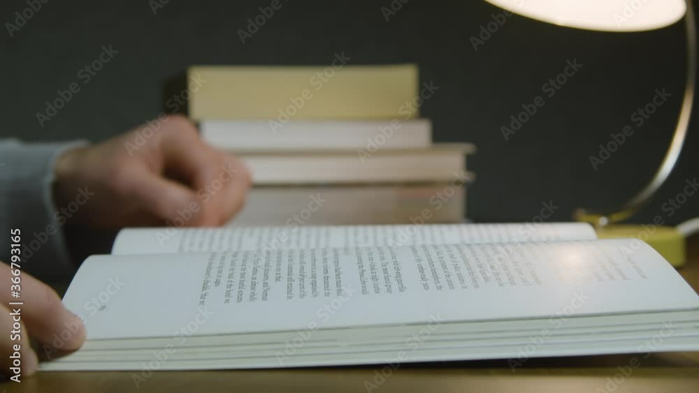 Close Up Side View Male Reading Book at Night