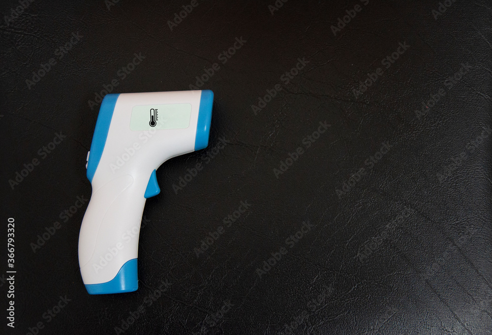 Digital Infrared Thermometer (thermometer gun) for check forehead temperature measurement scan from Coronavirus Pandemic 2019 (COVID-19). Isolated on black background. 
