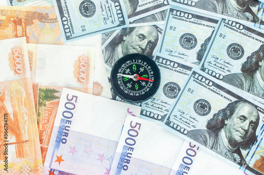 rubles dollars and euros with compass, the concept of currency volatility rubles dollars and euros with compass, the concept of currency volatility