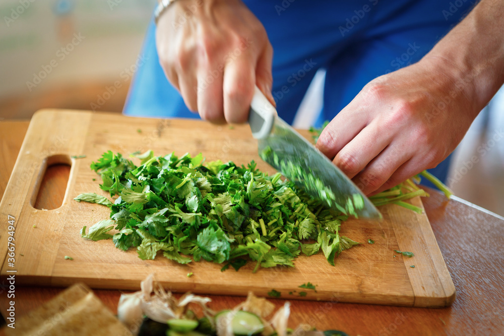 Fresh herbs are cut with a cooking knife Fresh herbs are cut with a cooking knife