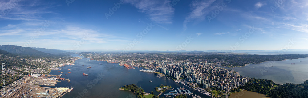 Downtown Vancouver, British Columbia, Canada. Aerial Panoramic View of the Modern Urban City, Stanley Park, Harbour and Port. Viewed from Airplane Above during a sunny day.
