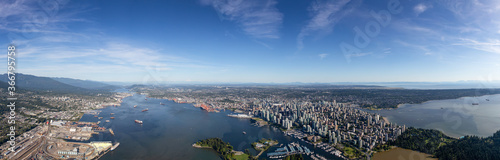 Downtown Vancouver  British Columbia  Canada. Aerial Panoramic View of the Modern Urban City  Stanley Park  Harbour and Port. Viewed from Airplane Above during a sunny day.