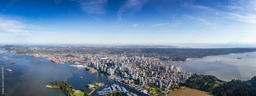 Fototapeta premium Downtown Vancouver, British Columbia, Canada. Aerial Panoramic View of the Modern Urban City, Stanley Park, Harbour and Port. Viewed from Airplane Above during a sunny day.