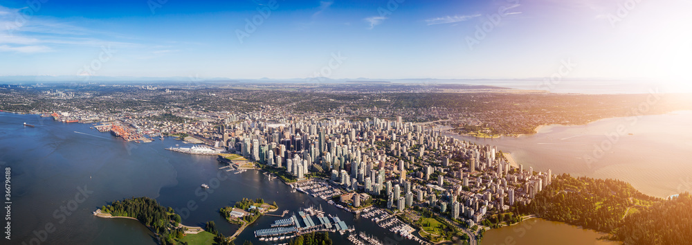 Fototapeta premium Downtown Vancouver, British Columbia, Canada. Aerial Panoramic View of the Modern Urban City, Stanley Park, Harbour and Port. Viewed from Airplane Above during a sunny day.