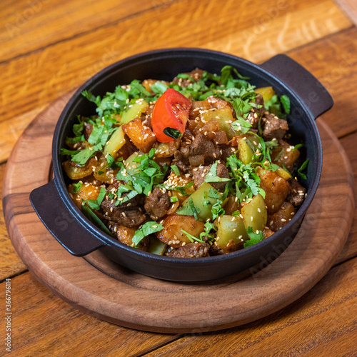 Tasty meat meal on the wooden plate