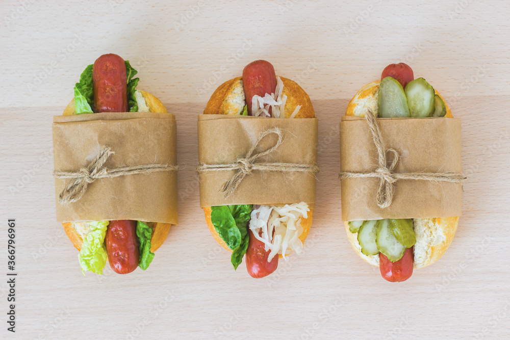 Hot dog with cabbage, hot dog with cucumbers and hot dog with green