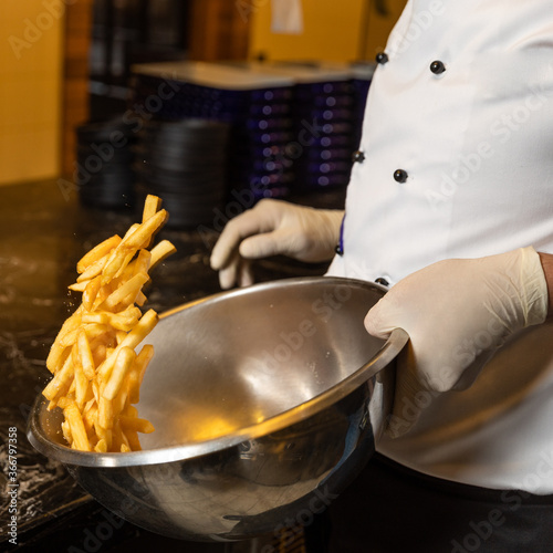 Chef cooking french fries close up