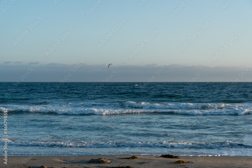 Kite surfing at sunset at Zuma beach, Malibu, Southern California