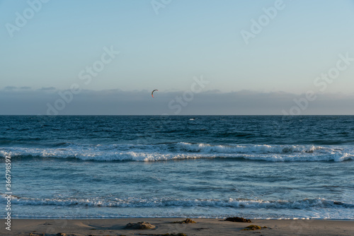 Kite surfing at sunset at Zuma beach, Malibu, Southern California