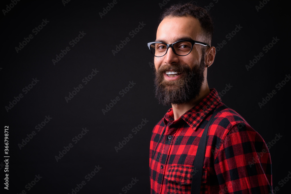 Young handsome Persian man with dreadlocks against black background Young handsome Persian man with dreadlocks against black background