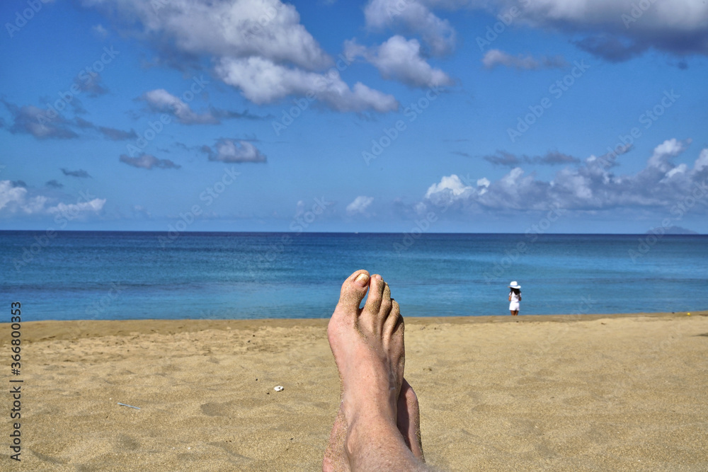 Relaxing barefoot on the beach in tropical Rincon, Puerto Rico