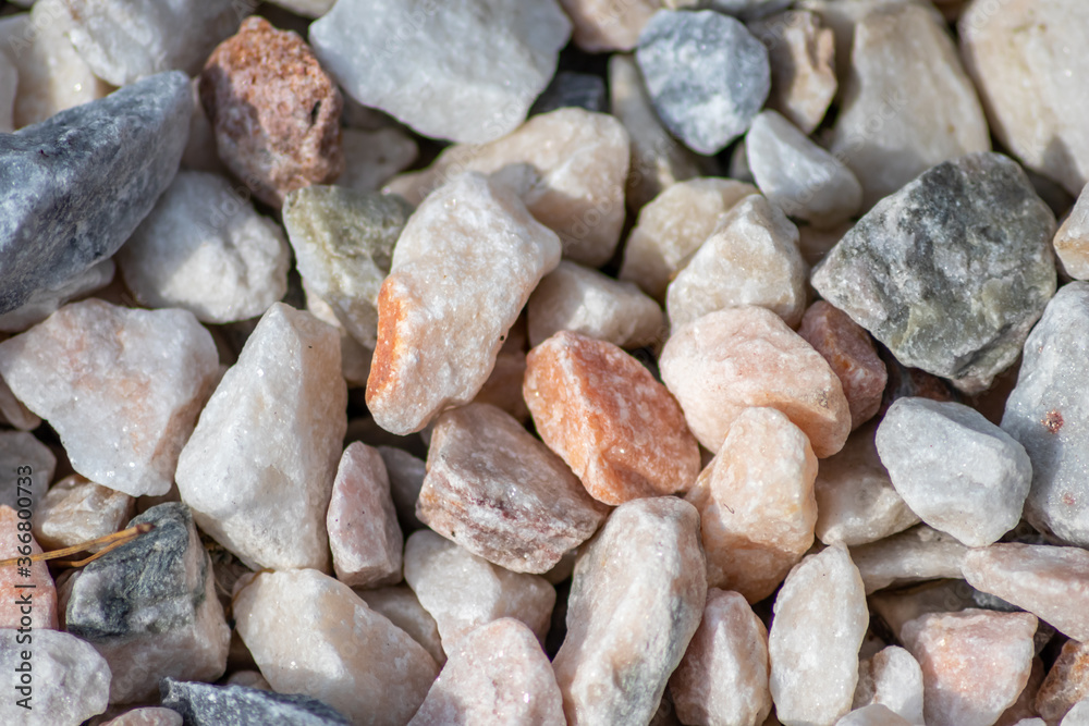 Raw rocks and minerals as natural stones background with crushed and rough material at a rough coast or rocky beach show nuggets and sandstones in harmonic pastel colors Raw rocks and minerals as natural stones background with crushed and rough material at a rough coast or rocky beach show nuggets and sandstones in harmonic pastel colors