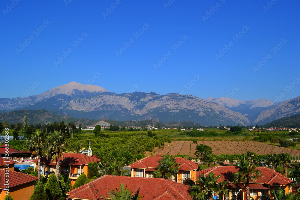 Mountains against a bright blue sky and beautiful clouds in summer